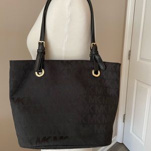 Michael Kors black canvas shoulder bag with gold detail, good used condition